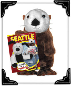 Elliott the Otter with a copy of Cooper's Pack Seattle book